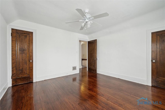 unfurnished room with ceiling fan, dark hardwood / wood-style flooring, and lofted ceiling