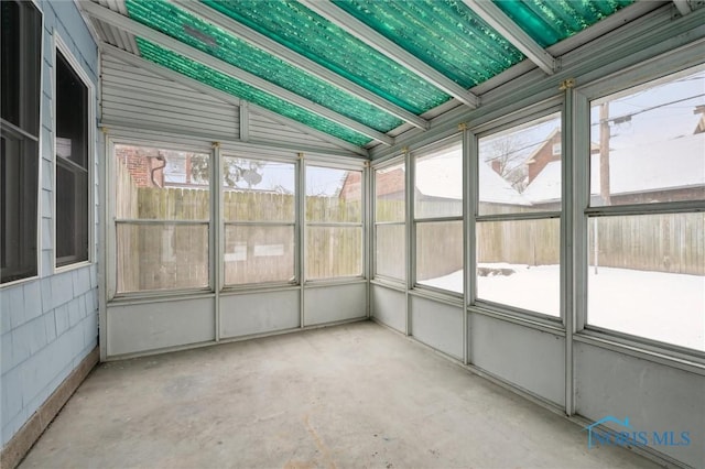 unfurnished sunroom featuring lofted ceiling