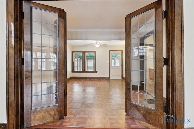 entryway featuring parquet flooring and french doors