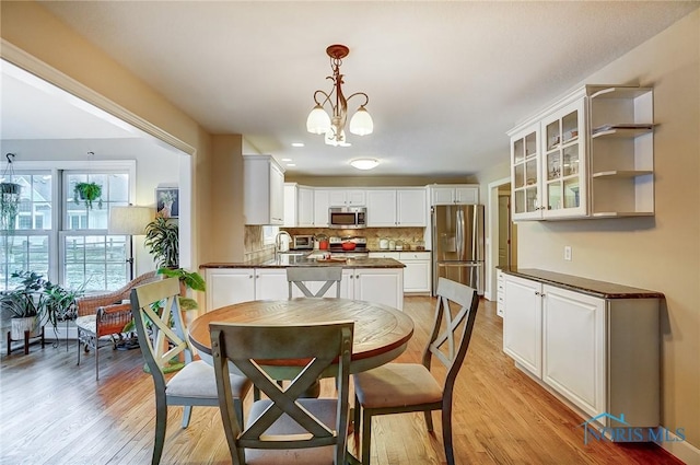 dining room with a chandelier and light hardwood / wood-style flooring