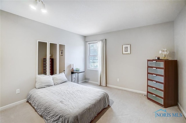 bedroom featuring light colored carpet