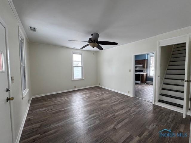 unfurnished room featuring ceiling fan, dark hardwood / wood-style flooring, and a wealth of natural light