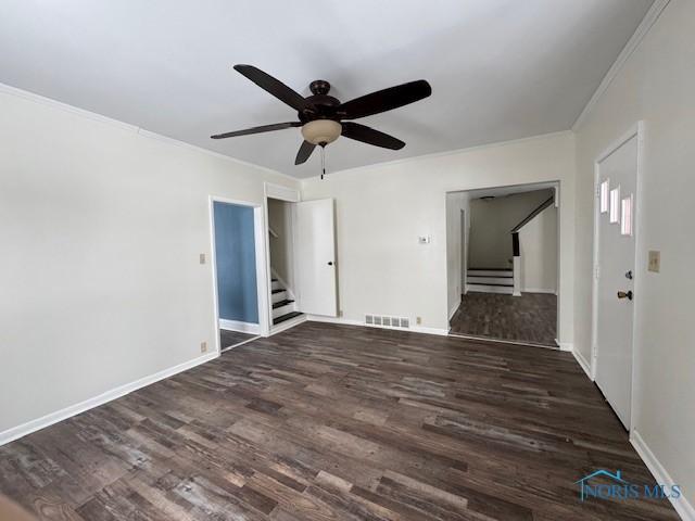 empty room featuring dark hardwood / wood-style flooring and ceiling fan