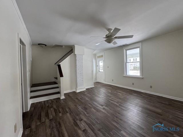 unfurnished living room featuring ceiling fan and dark wood-type flooring