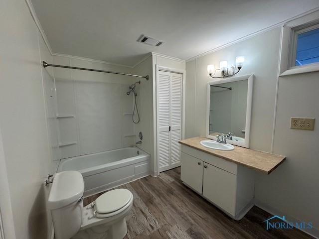 full bathroom with tub / shower combination, wood-type flooring, toilet, vanity, and ornamental molding