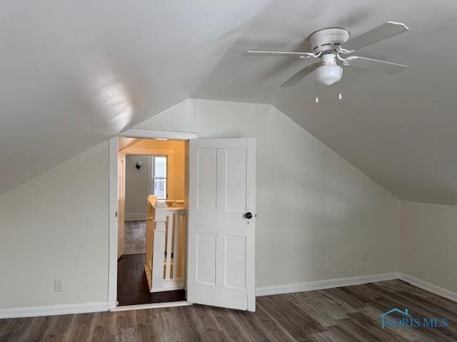 bonus room with ceiling fan, dark hardwood / wood-style flooring, and vaulted ceiling