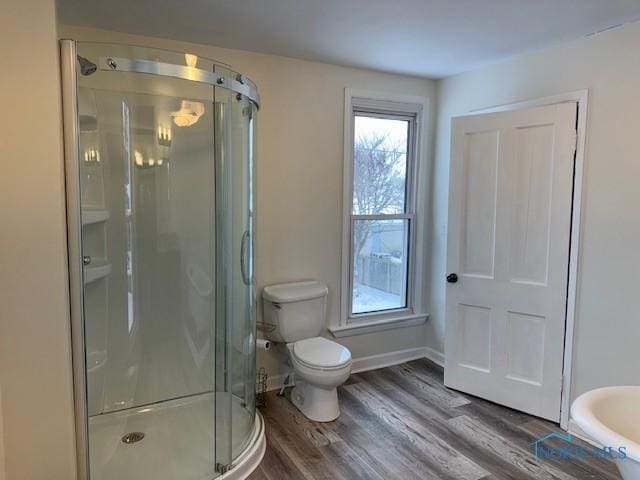 bathroom featuring hardwood / wood-style flooring, toilet, and an enclosed shower