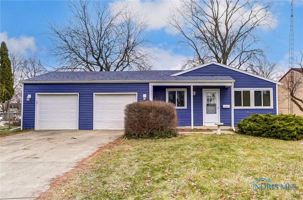 single story home with a front yard and a garage