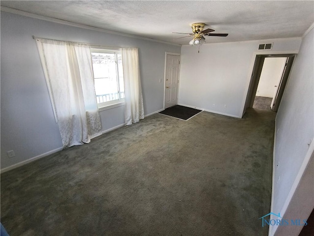 carpeted spare room featuring a textured ceiling and ceiling fan