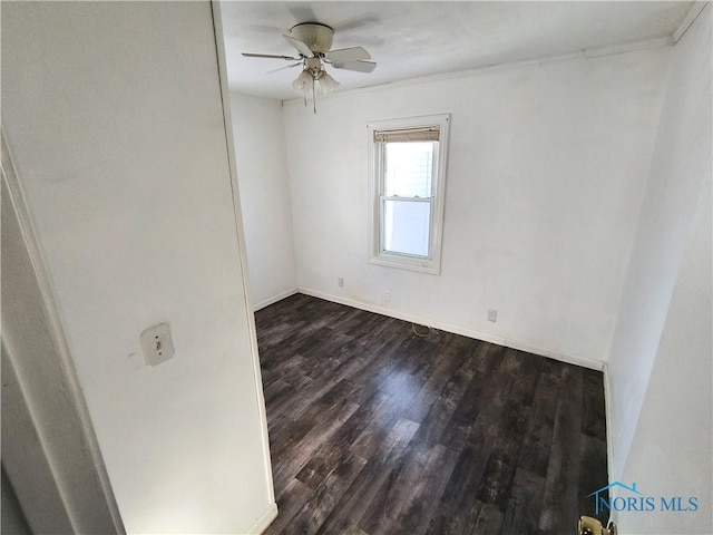 spare room featuring dark hardwood / wood-style floors and ceiling fan