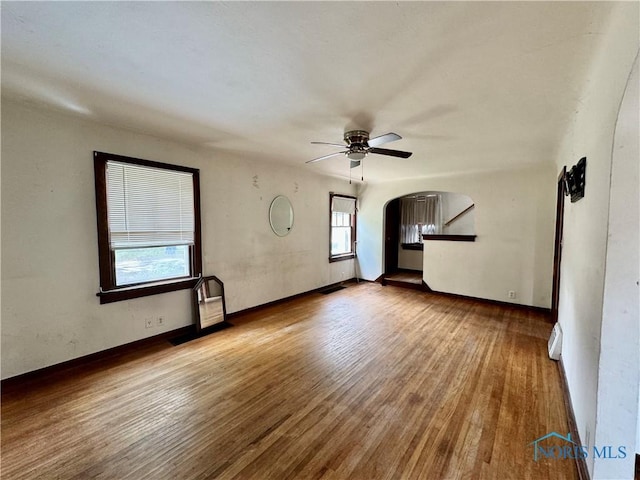 unfurnished living room with light wood-type flooring and ceiling fan