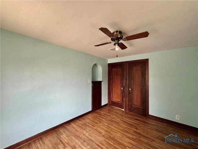 unfurnished bedroom with hardwood / wood-style flooring and ceiling fan