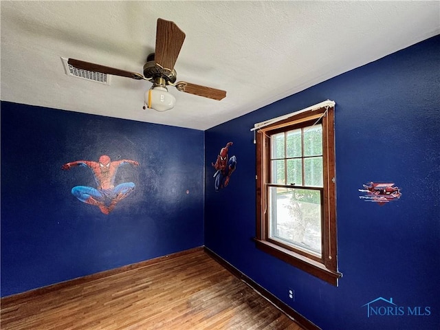 empty room featuring hardwood / wood-style flooring and ceiling fan