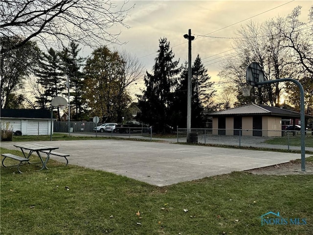 view of property's community featuring a yard and basketball court