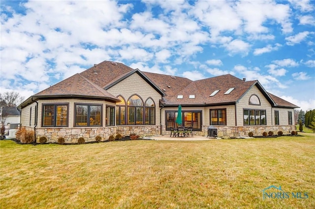 rear view of property featuring a patio area and a yard