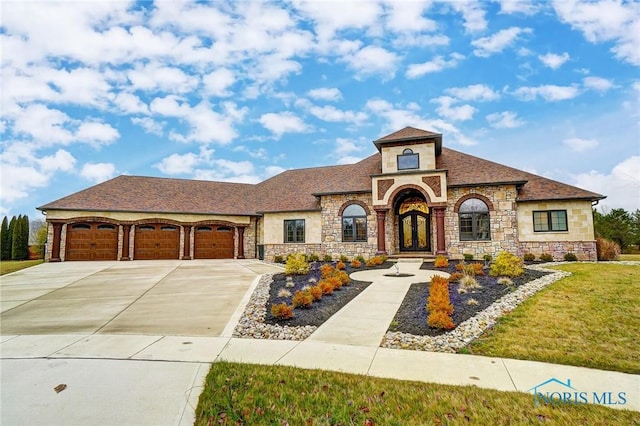 mediterranean / spanish house with a garage and a front lawn