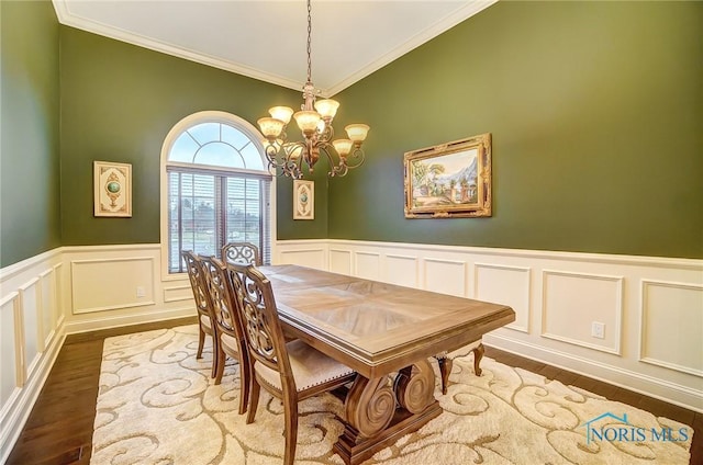 dining area featuring a chandelier, dark hardwood / wood-style flooring, and ornamental molding