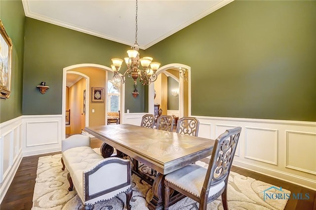 dining room with a chandelier, dark hardwood / wood-style floors, and ornamental molding