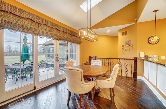 dining area with lofted ceiling, french doors, and dark hardwood / wood-style floors