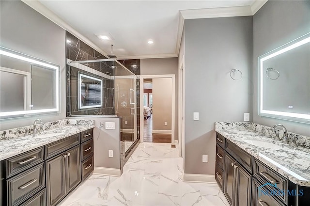 bathroom with vanity, a shower with shower door, and crown molding