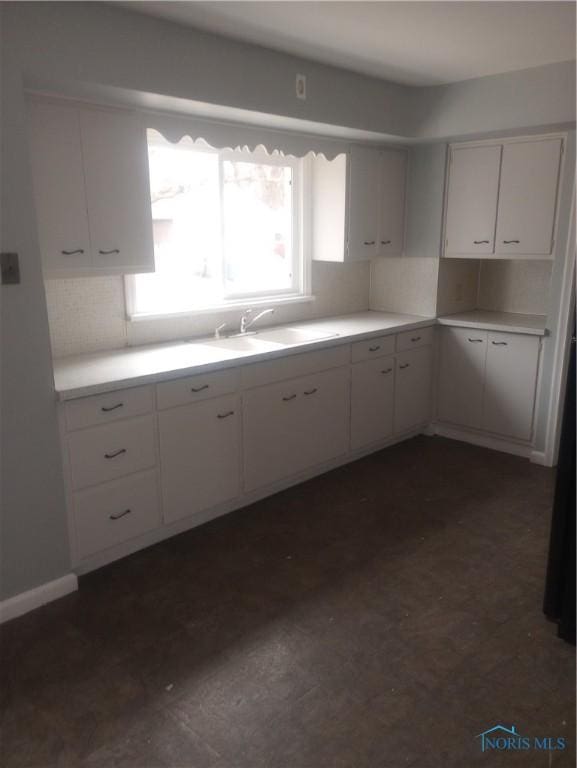 kitchen featuring white cabinetry and sink