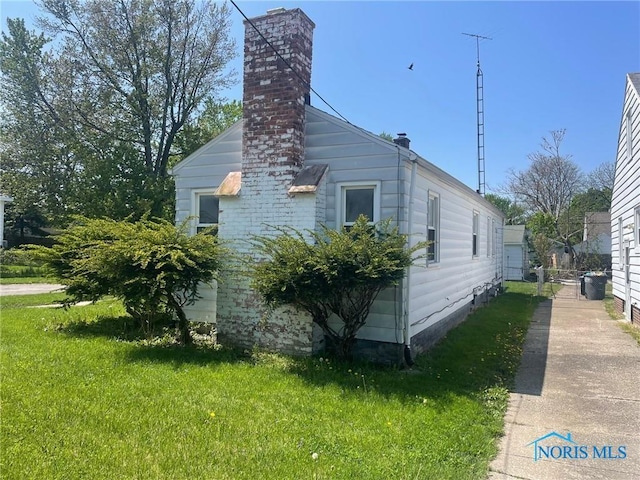 view of side of home featuring a yard