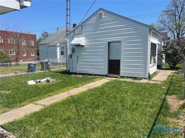 rear view of house featuring a lawn