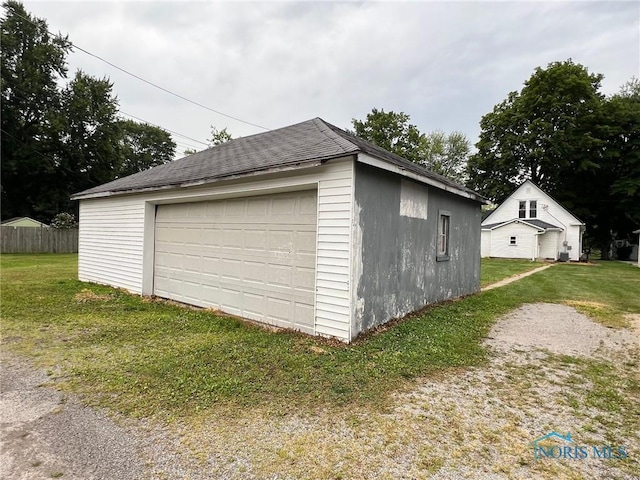 garage featuring a lawn