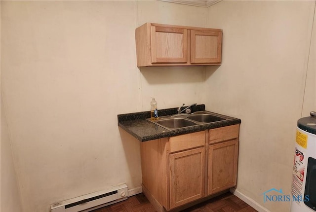 kitchen with dark parquet floors, a baseboard radiator, water heater, and sink