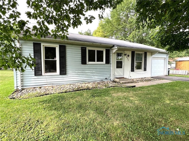 single story home with a garage and a front yard