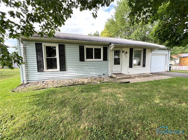 single story home with a front yard and a garage