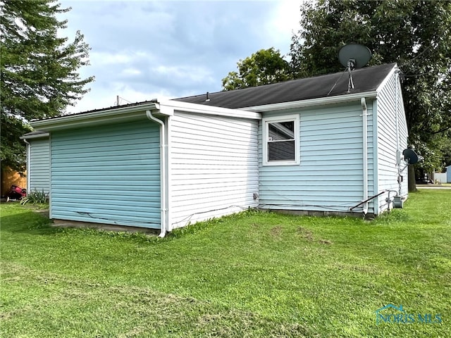 view of property exterior with a lawn