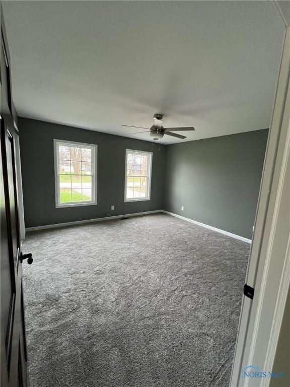 unfurnished room featuring carpet flooring and ceiling fan