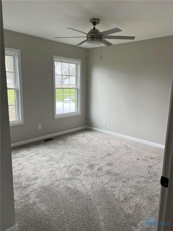 carpeted empty room featuring ceiling fan