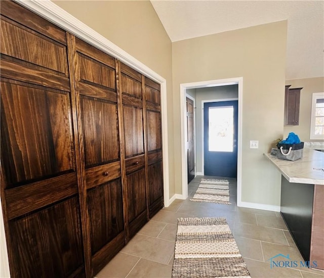 interior space featuring lofted ceiling, light tile patterned floors, and a wealth of natural light