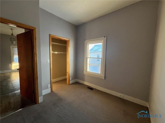 unfurnished bedroom featuring carpet and a closet