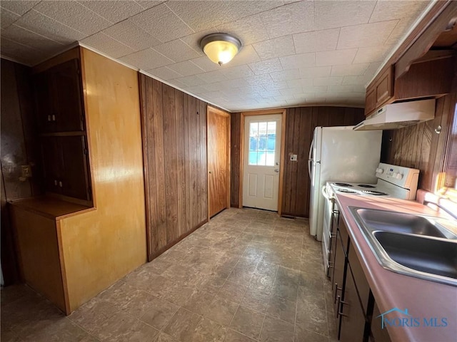 kitchen featuring wood walls, sink, and electric range oven