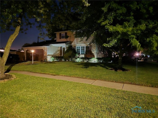 view of front of home with a front yard and a garage