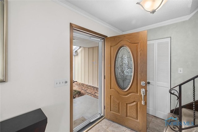 tiled foyer with ornamental molding