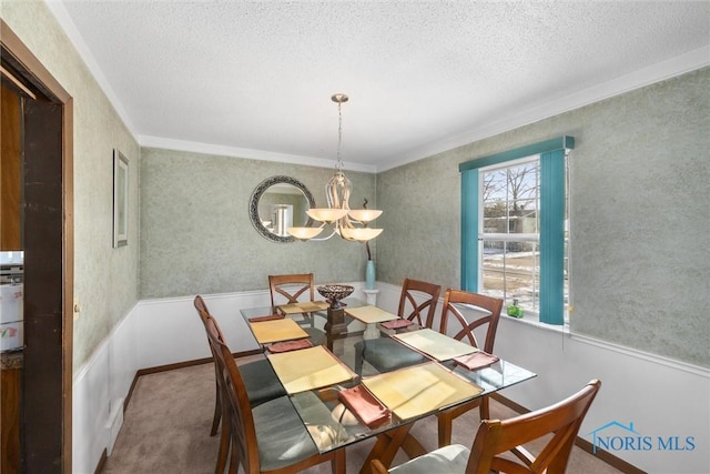 carpeted dining space with a textured ceiling, crown molding, and a chandelier