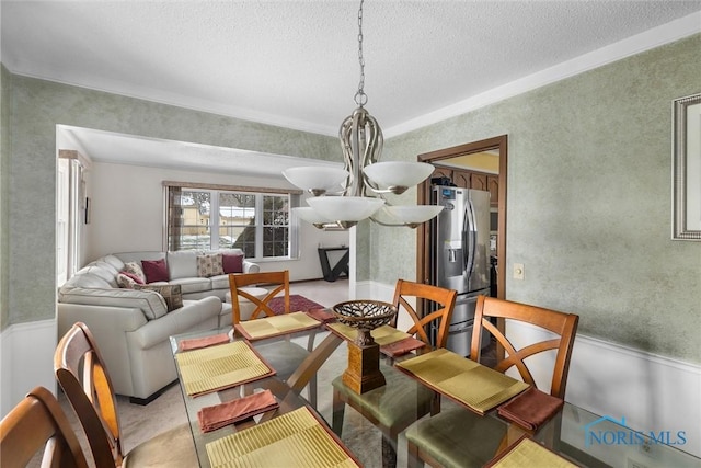 dining area with a textured ceiling and a notable chandelier