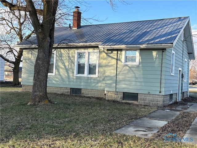 view of property exterior with a yard