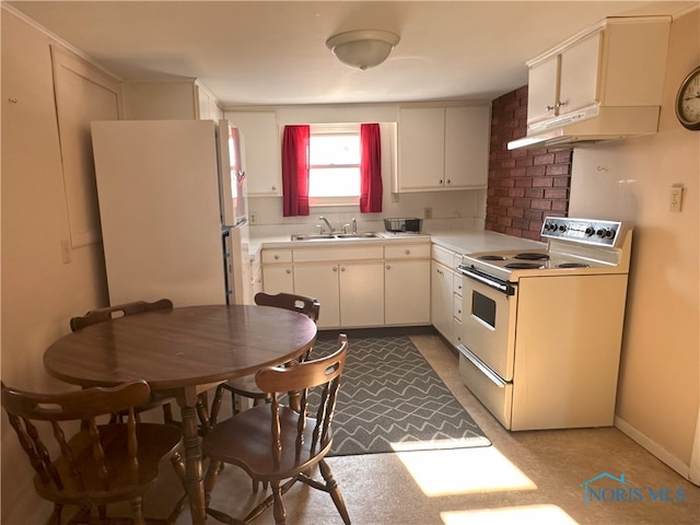 kitchen with sink, white refrigerator, white cabinetry, and electric stove