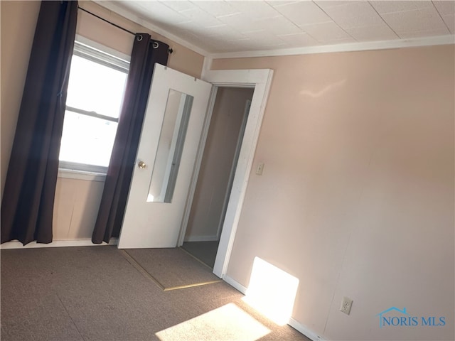 unfurnished room featuring ornamental molding