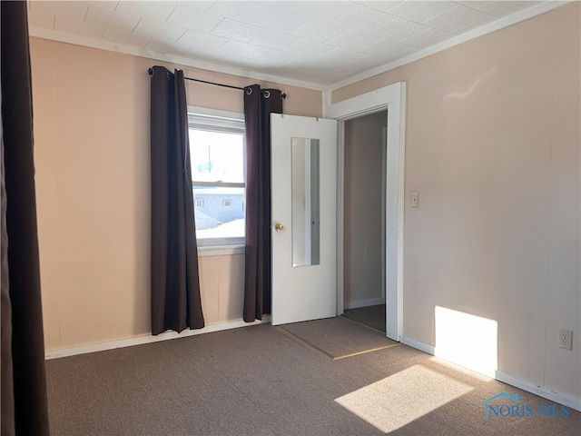 carpeted empty room with ornamental molding