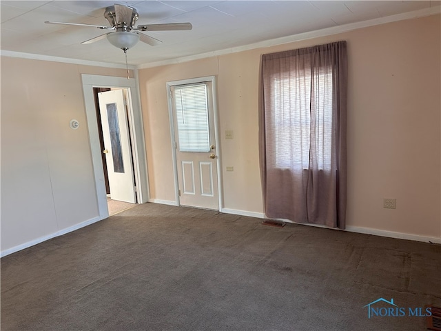 spare room featuring carpet floors, ceiling fan, and ornamental molding