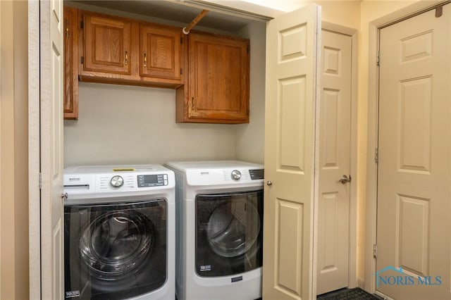 laundry room featuring cabinets and separate washer and dryer