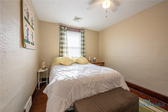 bedroom featuring ceiling fan and dark wood-type flooring