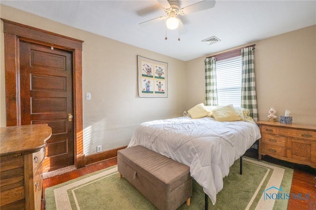 bedroom with ceiling fan and dark hardwood / wood-style flooring