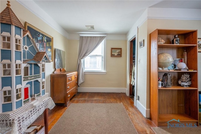 interior space with hardwood / wood-style flooring and ornamental molding